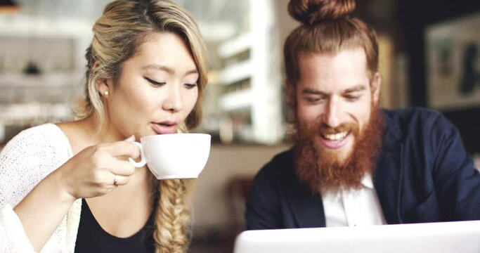 Cafe, coffee cup and couple on laptop with funny internet meme, reading website or social media for valentines day. Young man and woman laughing, talking and streaming on computer at a restaurant