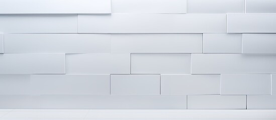 White ceramic tiles arranged neatly on a plain white wall creating a clean and modern look