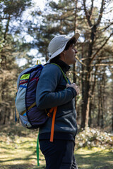 vertical portrait Hiker Trekking Through Forest with¡h backpack at Summer Sunset