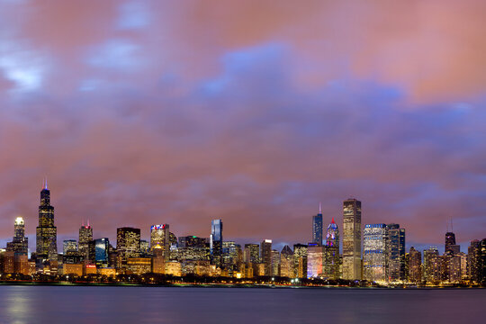 Panoramic image of Chicago skyline at sunset with dramatic sky.