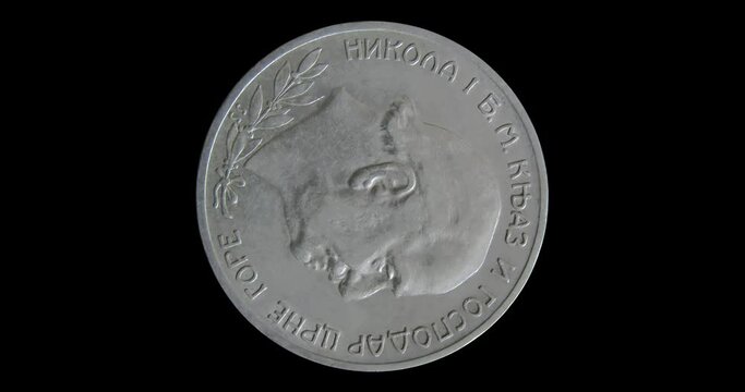Obverse of Montenegro 2 perpera 1910 with inscription meaning NICHOLAS D.G. PRINCE AND SOVEREIGN OF MONTENEGRO. Isolated in black background. Seamless animation in 4k video