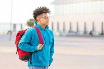 Student walking with backpack and looking away