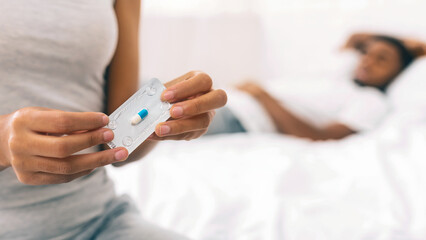 Black woman taking oral emergency contraceptive after sex