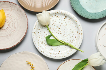 Table setting with beautiful tulips on grey background