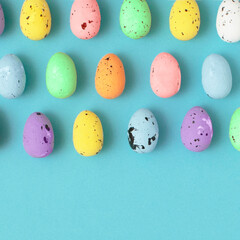 Easter pattern made of colorful eggs in bright colors. Creative food flat lay.