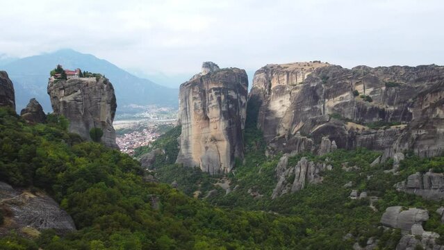 Aerial view of Monastery of the Holy Trinity (Agia Triada) in Meteora, Greece with Kalabaka town and mountains in the background