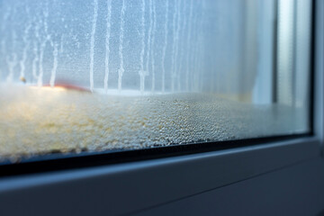 Indoor close-up of a leaky window. Condensate water on window - 769130954