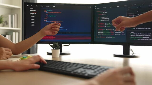 Back end software developer engineer for computer programming working together on debugging writing computing code, solving complex algorithms display on monitor in office. Burgeoning