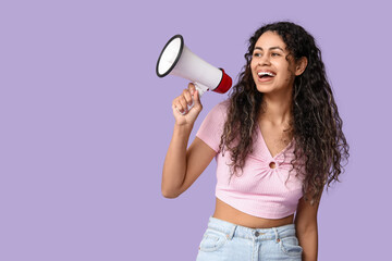 Young African-American woman with megaphone on lilac background