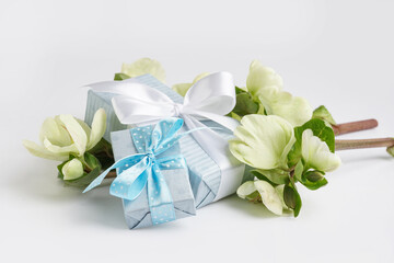 Obraz na płótnie Canvas Gift boxes and branches with beautiful flowers on white background
