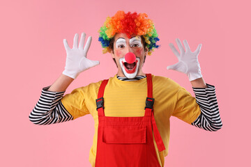 Portrait of happy clown with on pink background. April Fool's day celebration