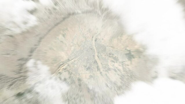 Earth zoom in from space to Biskra, Algeria. Followed by zoom out through clouds and atmosphere into space. Satellite view. Travel intro. Images from NASA