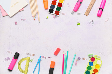 Frame made of different stationery on white grunge background. Top view