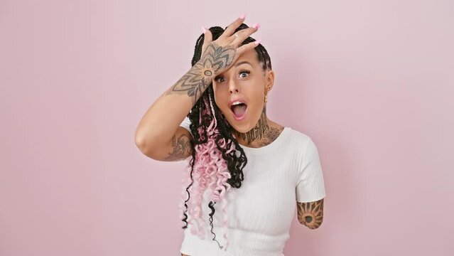 Oops! confused hispanic amputee woman standing over pink isolated background, hand on head, stressing over forgotten mistake. bad memory or blunder concept.