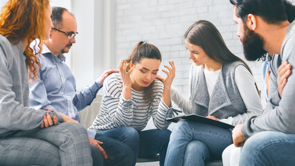 Depressed woman sharing her problems with group on therapy session