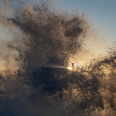 Waves crashing on cliffs at sunset. High quality photo