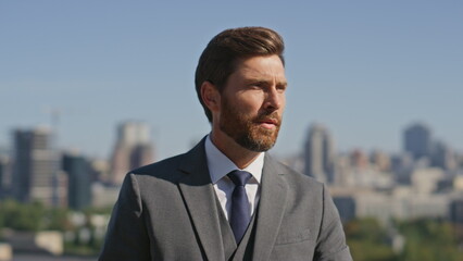 Confident gentleman posing street in elegant suit close up. Portrait businessman