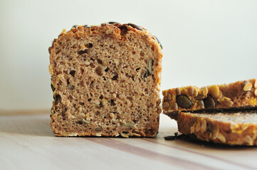Brown bread with pumpkin seeds on a wooden board
