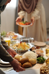 Unrecognizable Muslim Women Setting Table On Uraza Bayram