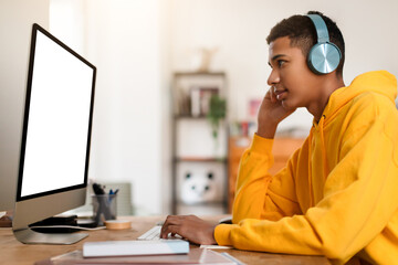 Man in yellow hoodie working at computer