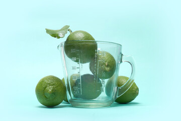 Limes with Glass Juicer: Fresh Citrus for Juicing
