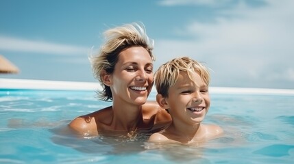 Fototapeta premium Happy Mother and Son Swimming in Resort Pool