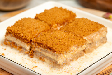 Baklava with biscuits and milk. Cold baklava with biscuits on a wooden serving board. Famous dishes of Turkish cuisine
