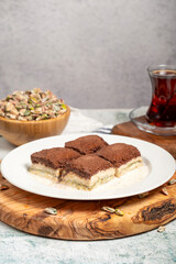 Dark chocolate and milk baklava. Cold baklava with chocolate on a wooden serving board. Famous dishes of Turkish cuisine