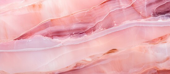 A close up of a pink marble texture resembling a blend of magenta and peach hues, perfect for...