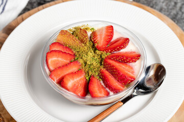 Strawberry magnolia dessert. Strawberry pudding dessert on wooden serving board. Famous dishes of Turkish cuisine