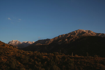 landscape with mountain peaks background the sky with clouds at sunset in autumn