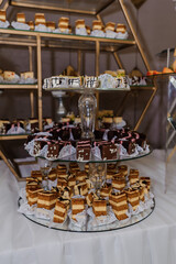 Sweet cakes at a wedding banquet. Catering, sweet festive buffet. Candy, chocolate bar. Mousse cakes