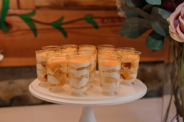 Sweet cakes at a wedding banquet. Catering, sweet festive buffet. Candy, chocolate bar. Mousse cakes