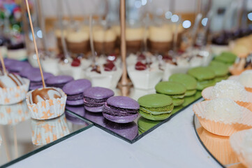 Candy bar with sweet almond cakes at the wedding buffet. Sweet cakes at the festive buffet