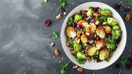 Wandaufkleber Fried brussels sprouts salad with quinoa, cranberries and nuts in a white bowl. © Vasiliy