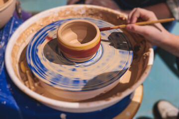 Pottery lesson master class for kids children, process of making clay pot on pottery wheel, potter hands creating ceramic crockery handcrafts, ceramist molding and painting jar or vase
