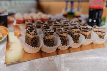 Sweet cakes at a wedding banquet. Catering, sweet festive buffet. Candy bar
