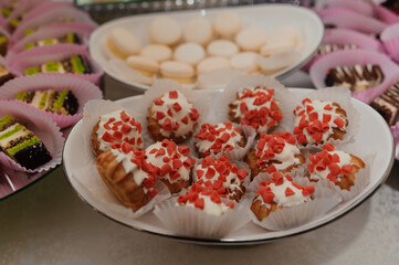 Sweet cakes at a wedding banquet. Catering, sweet festive buffet. Candy bar