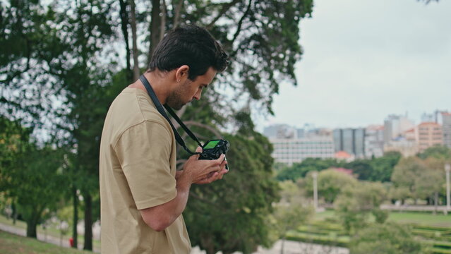 Young photographer shooting cityscape on professional camera close up. Man photo