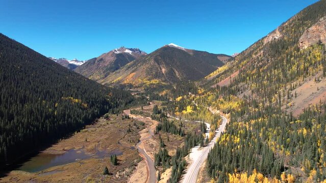 Drone Aerial Colorado Million Dollar Highway Road Yellow Aspen Pine Trees Snow Top Mountains. Winding Yellow River