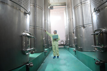 Winemaker working in modern large winery factory drink industry  and  testing wine in a wine factory warehouse - 769180599