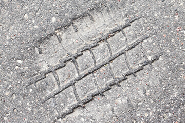 Melt asphalt imprint. Tyre mark texture. Tire track on the road background. Highway damaged with...