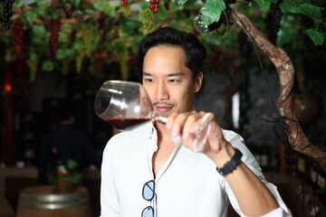 handsome man sommelier tasting red wine - 769182318