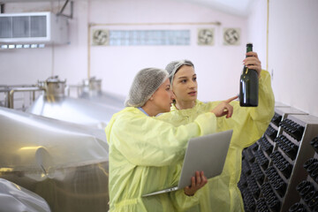 Winemaker working in modern large winery factory drink industry  and  testing wine in a wine factory warehouse