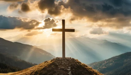 Fotobehang jesus christ cross easter resurrection concept christian cross on a background with dramatic lighting colorful mountain sunset dark clouds and sky and sunbeams © Leila