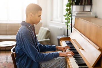 Young musician practicing piano in a peaceful room