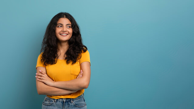 Woman crossing arms and looking away thoughtfully