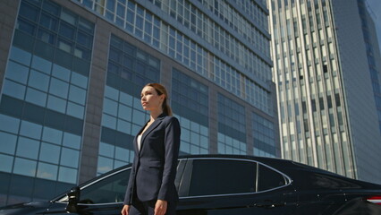 Posh businesswoman posing downtown sunny morning. Elegant woman manager standing