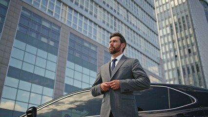 Millionaire posing luxury car looking camera confidently. Man standing at auto