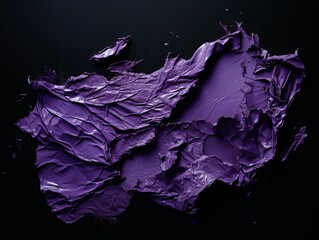 torn purple papper on a black background